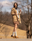 A woman in cute fall fashion wearing stylish tan clogs.