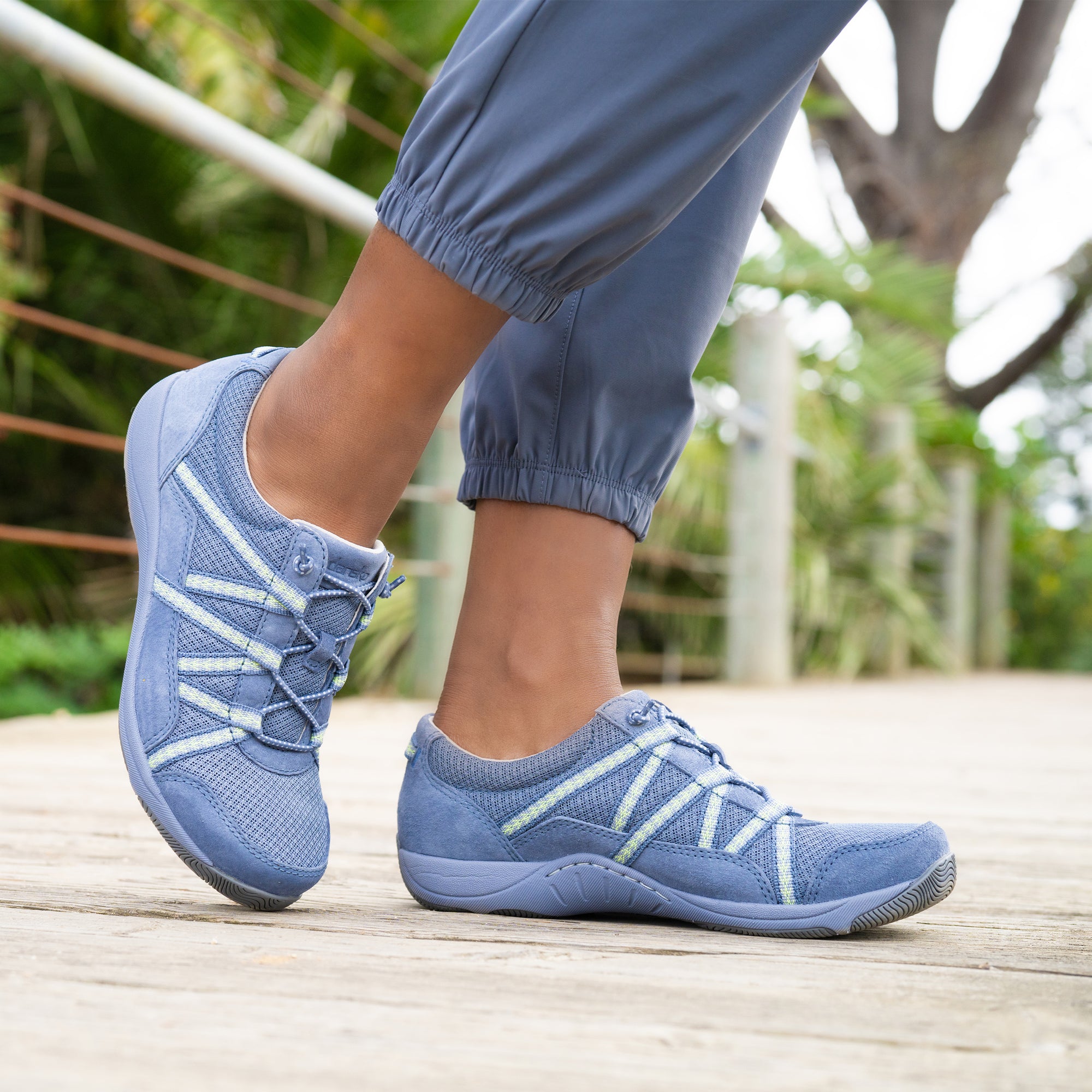 A close up on thin light blue sneakers.