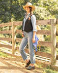 A farm girl wearing black clogs with a flower pattern styled with denim.