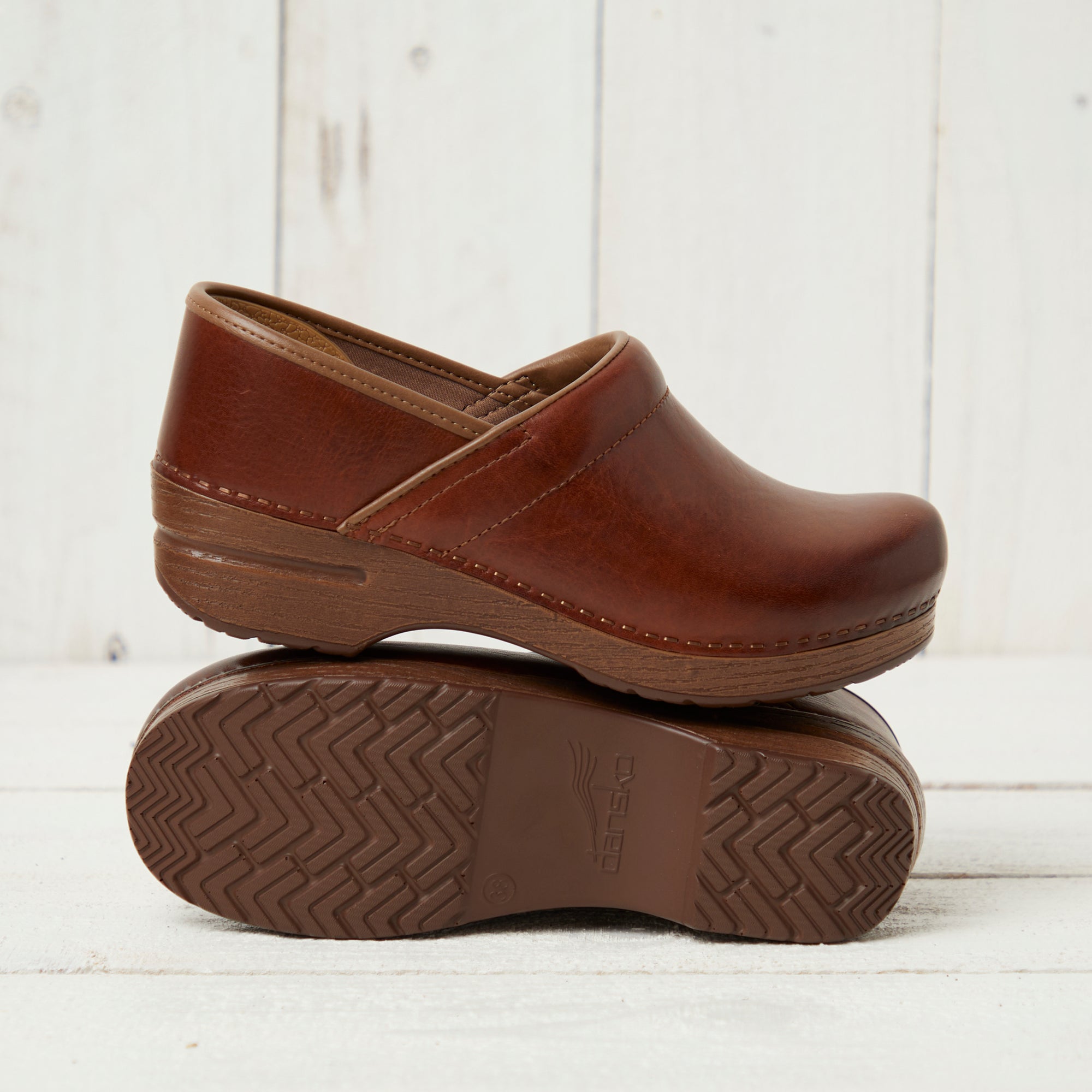 Professional saddle leather clog showing outsole detail.