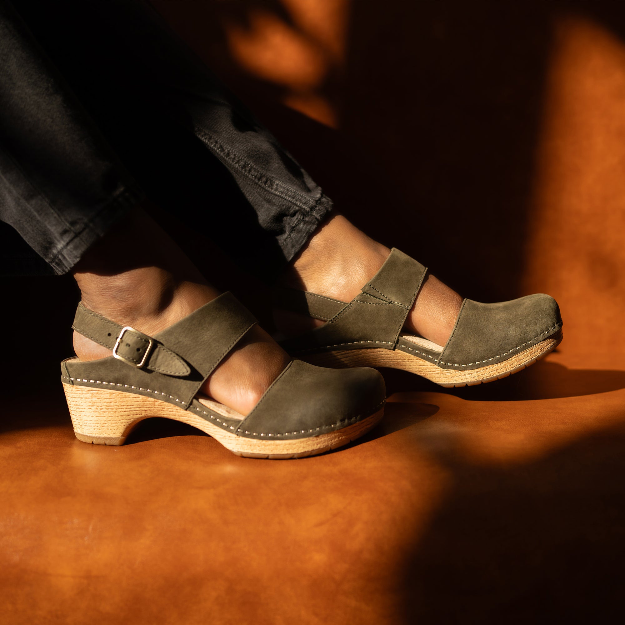 A close up of ivy transitional sandals shown on foot.