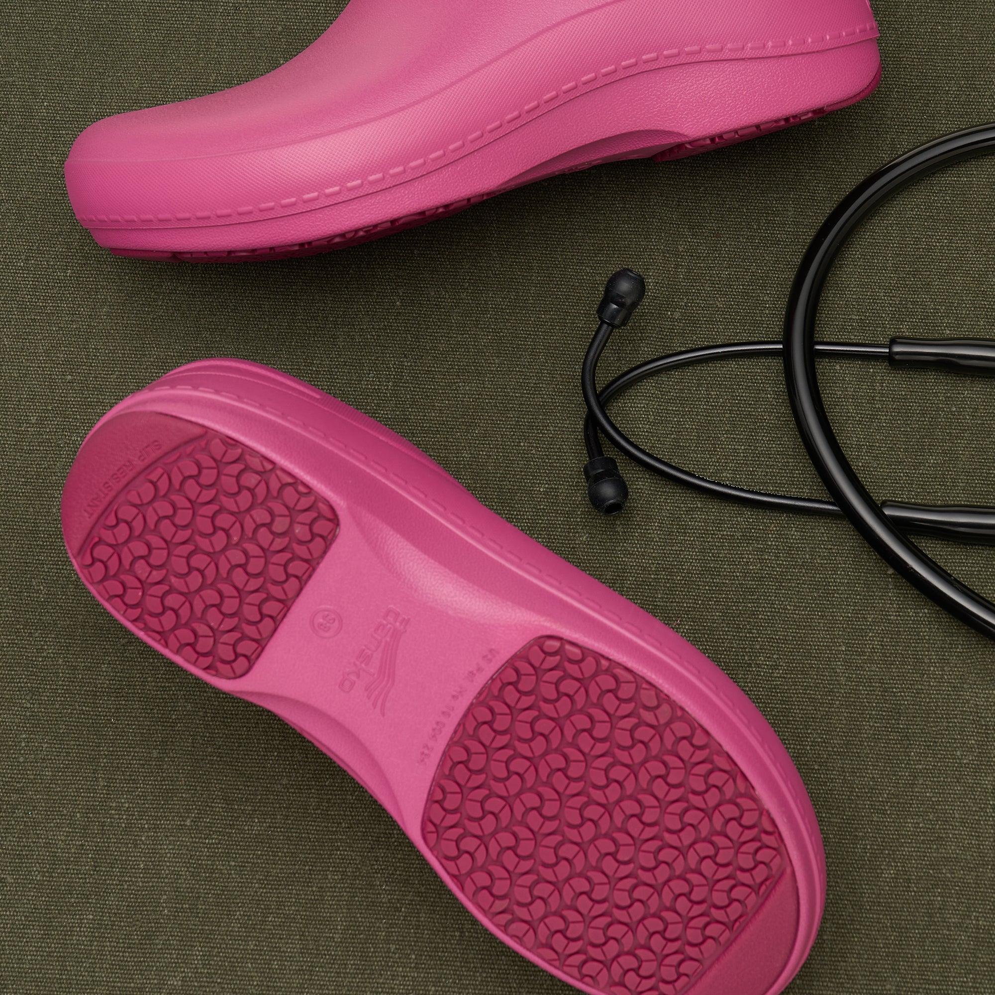 A closeup of pink molded clogs showing the patented nonslip EVA outsole pattern.