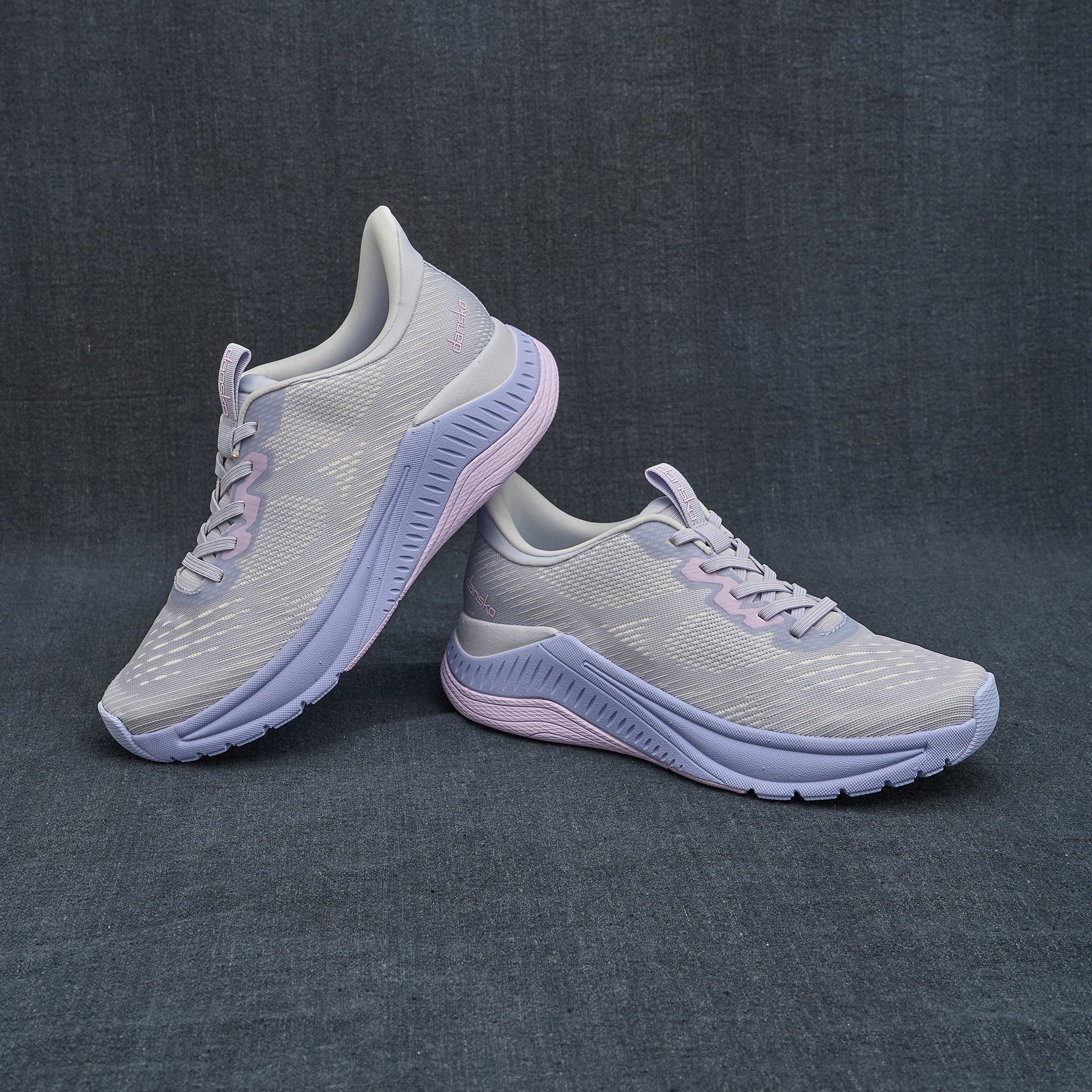 A styled shot of lilac performance walking sneakers.
