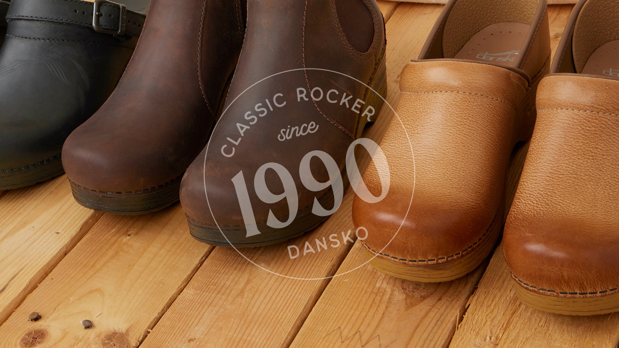 Black mule clogs, brown boots, and honey brown clogs from Dansko shown.