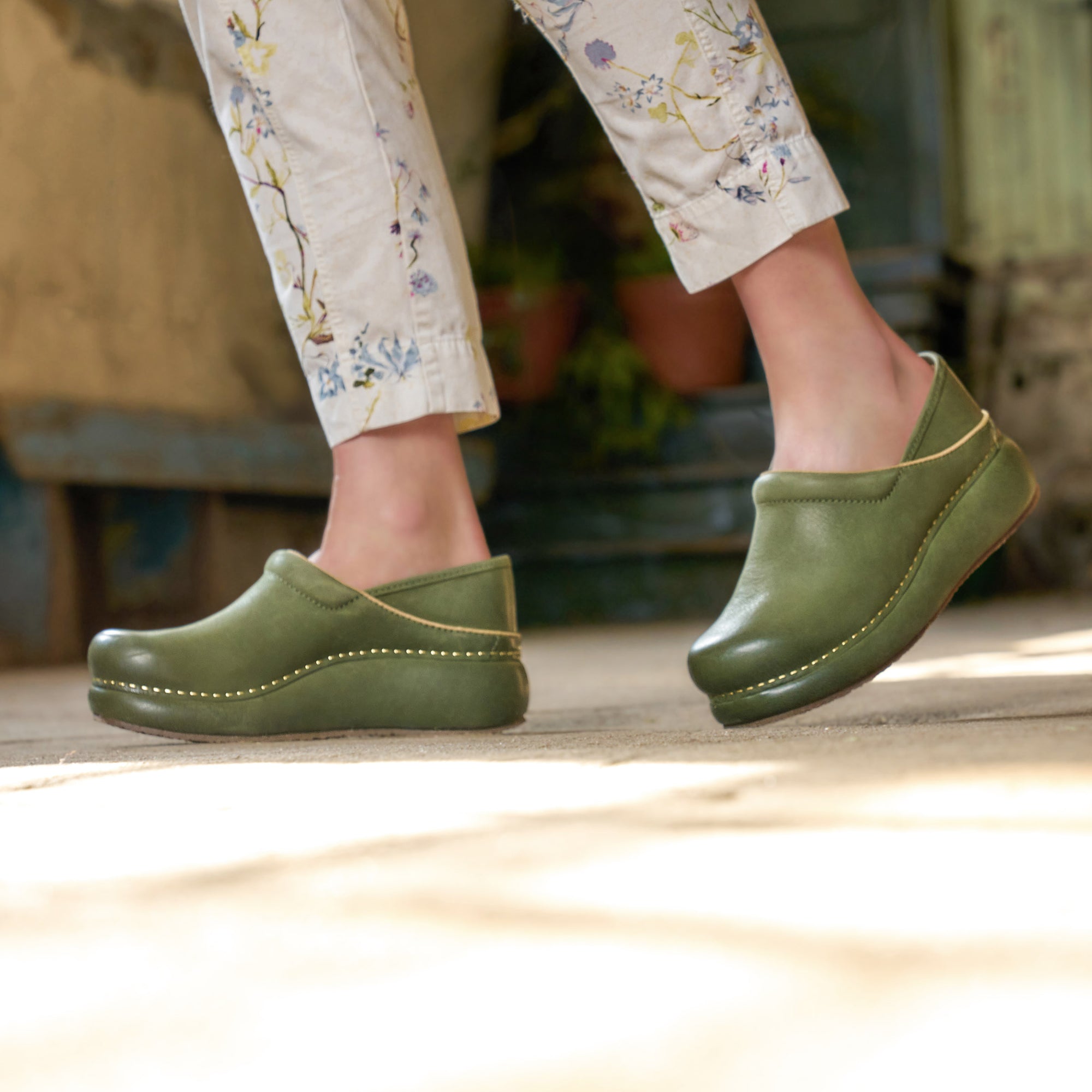 Close up of green platform Dansko clogs.