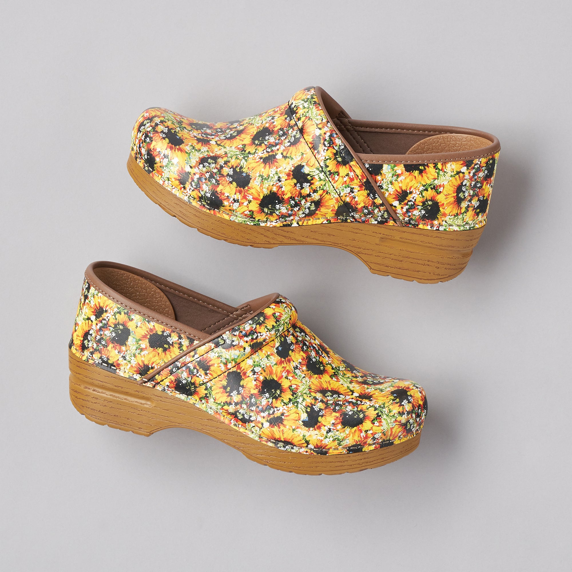 A side view of sunflower leather clogs with a faux leather sole.