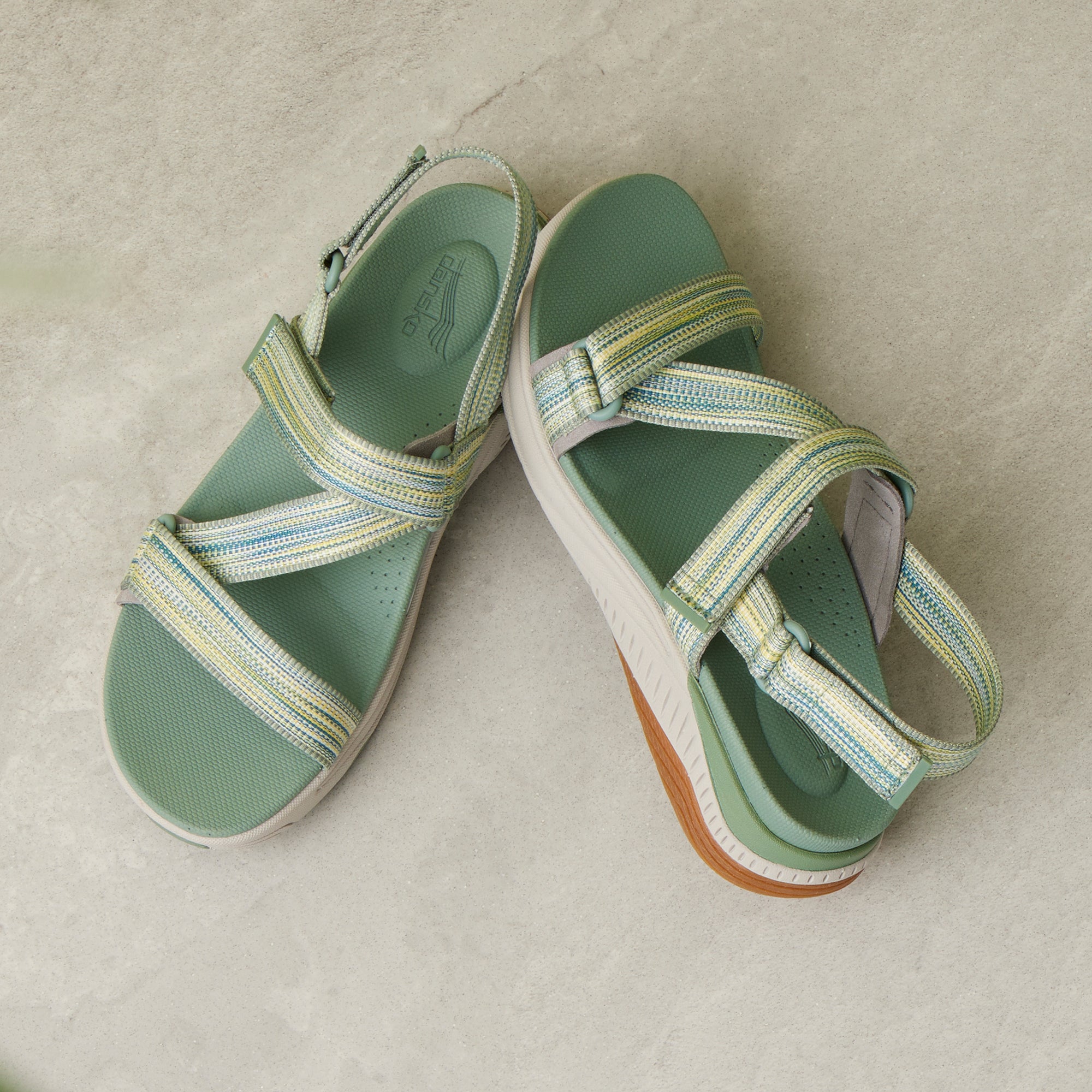 A detailed footbed and strap image of green walking sandals.