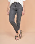 Metallic leather flat sandals shown worn with black jeans.