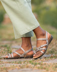 Close up of metallic strappy flat sandals