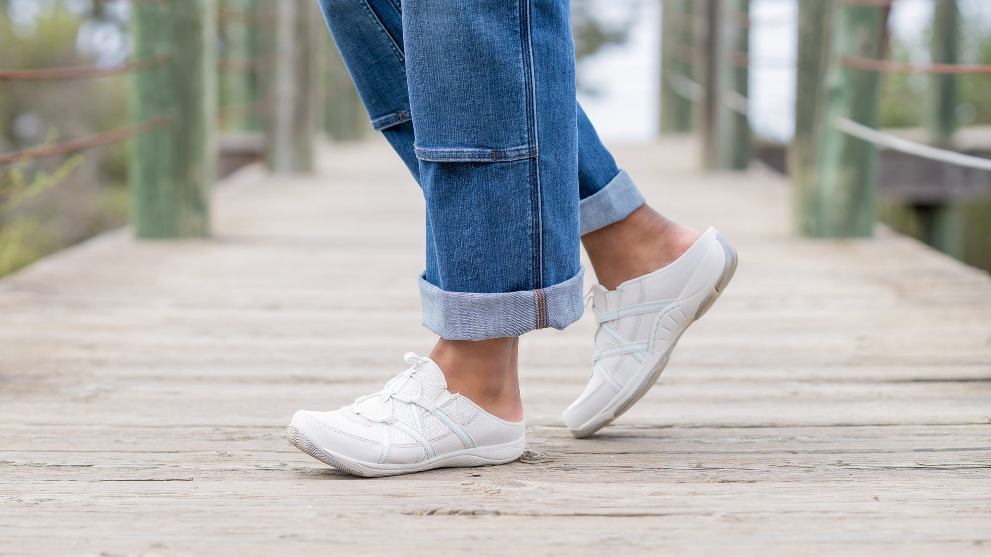 Lightweight white mule sneakers with elastic adjustability.