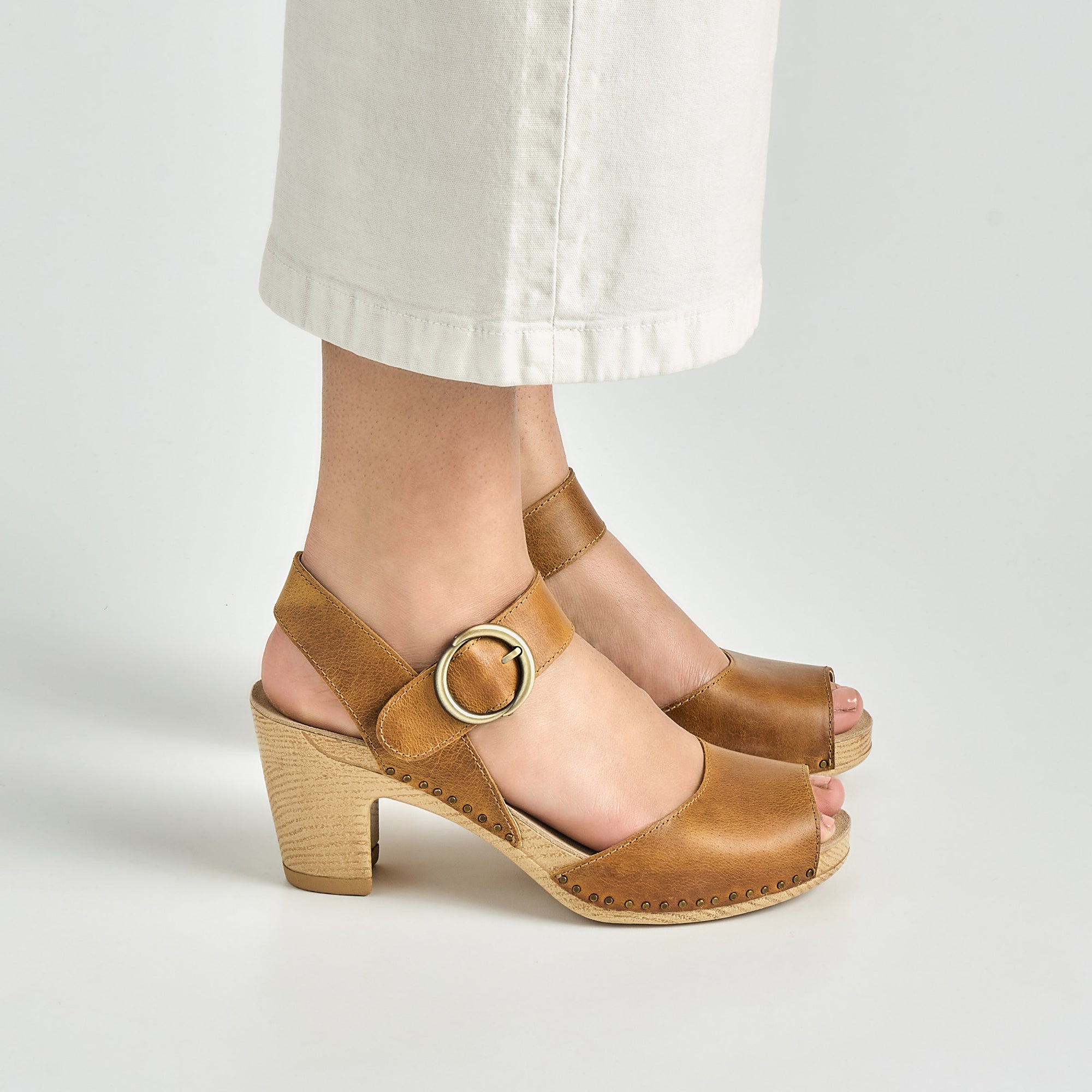 Close up of tan high heeled mary janes.