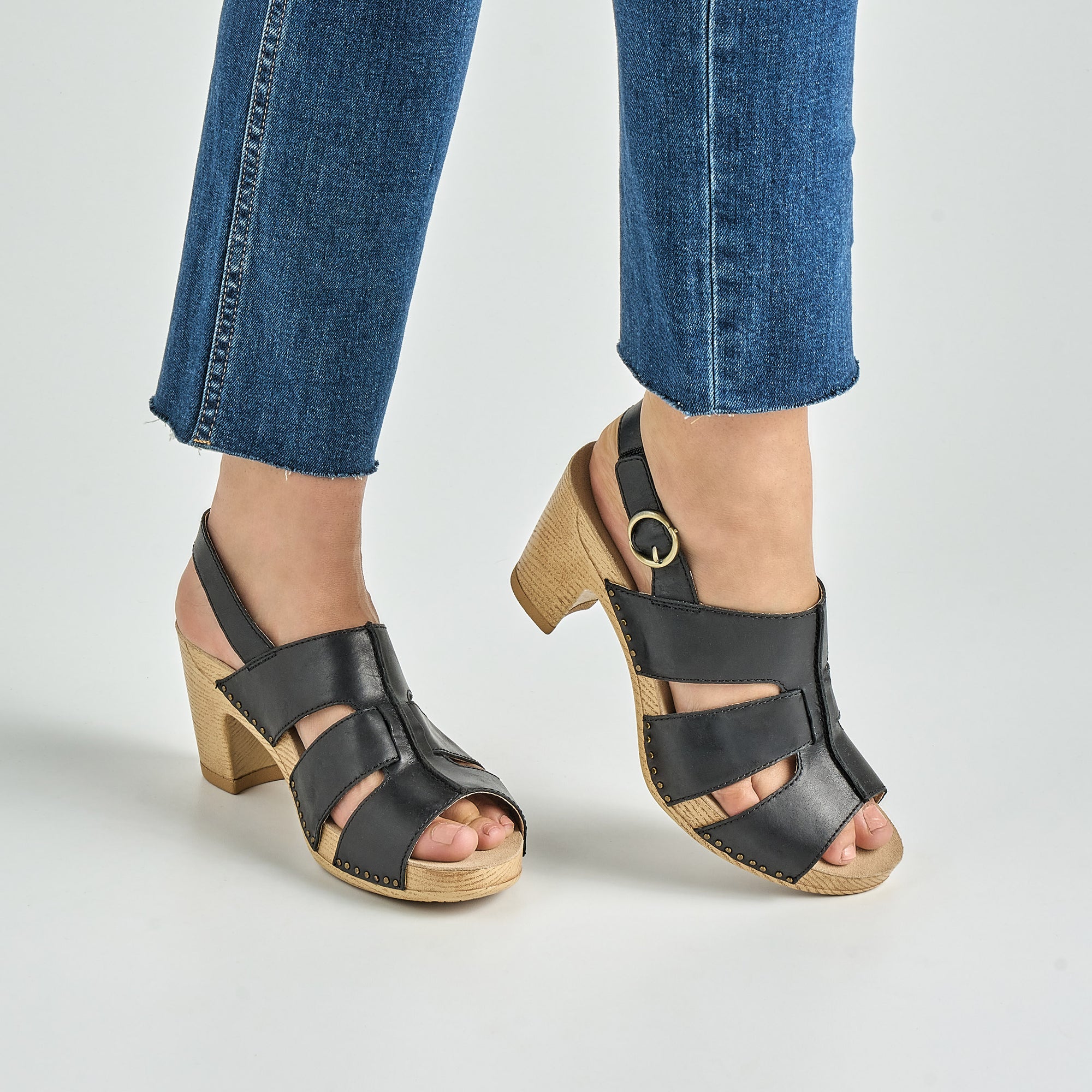 Close up of black heeled sandal.