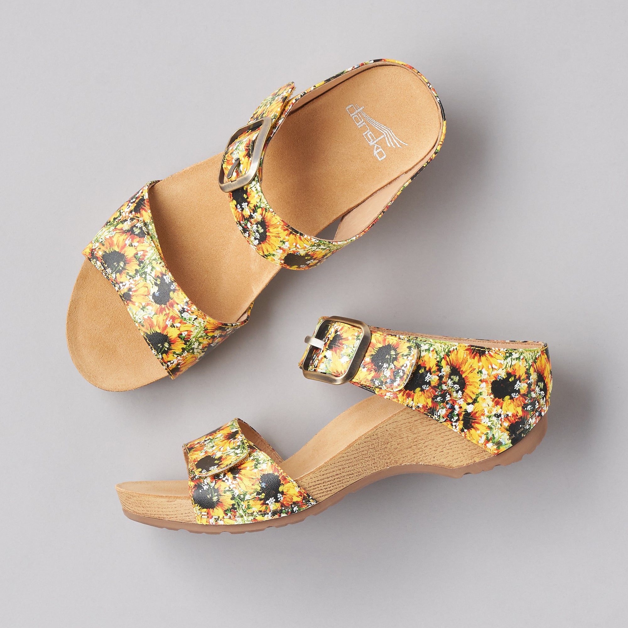 Two angles shown of the bright sunflower printed two-strap sandals.