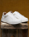 White leather sneakers with tan accents for a stylish casual option.