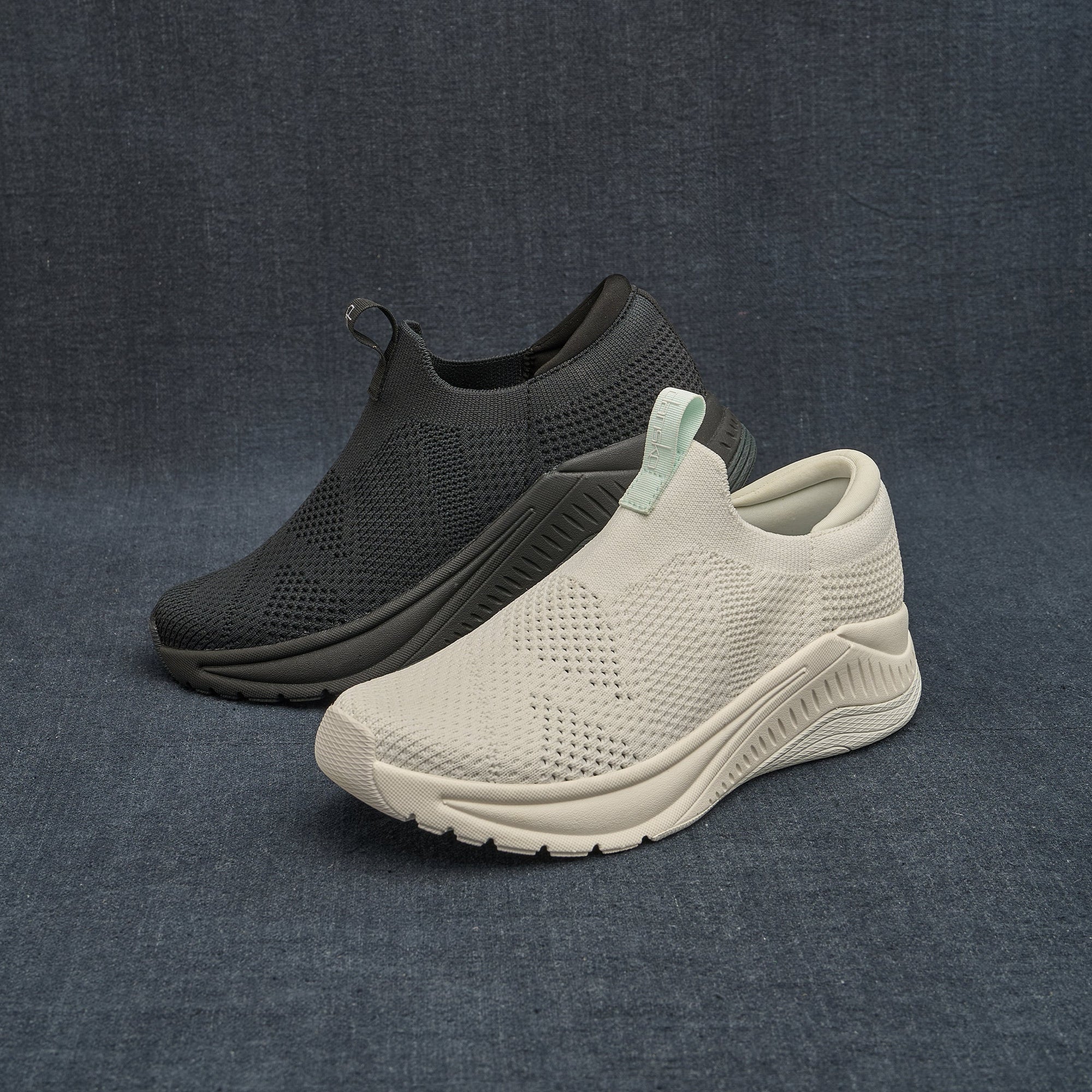 Two colorways of slip-on, lightweight sneakers on dark backdrop.
