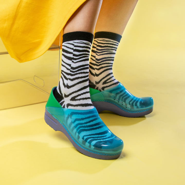 Blue Translucent clogs with zebra patterned socks and a yellow dress.
