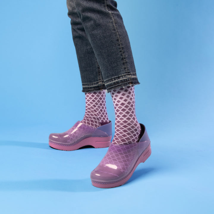 Purple Translucent clog with designed purple socks and dark jeans.