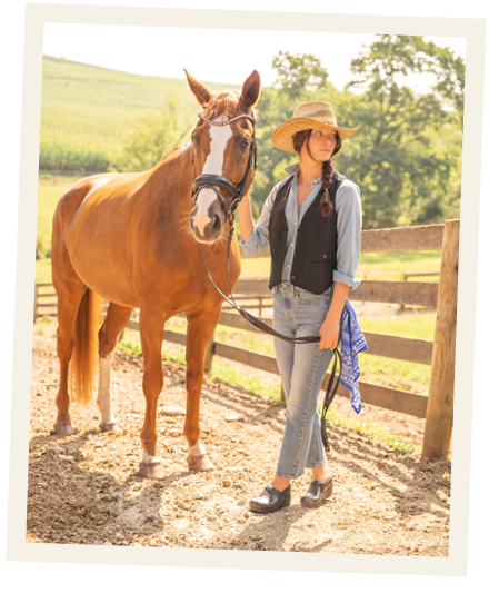 Woman standing beside a horse outdoors