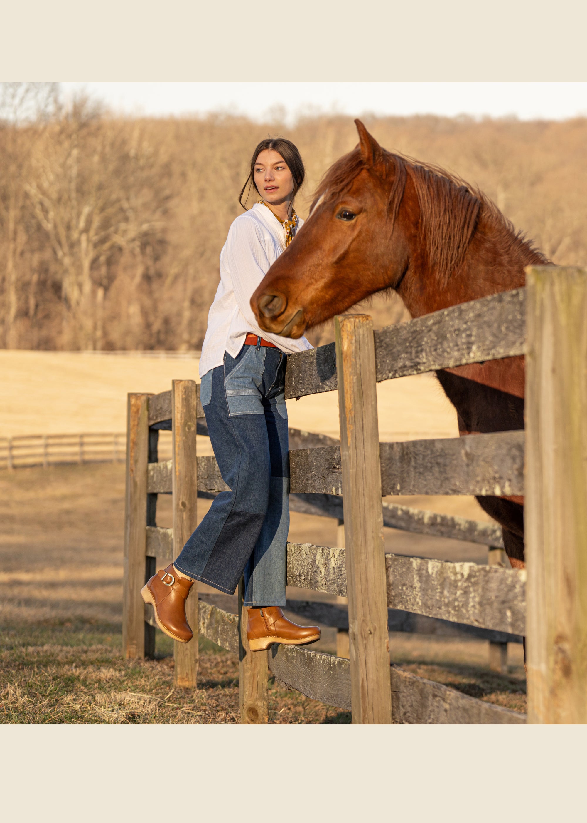 A woman working with a horse while wearing brown leather booties.