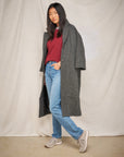 A woman in autumn attire wearing grey sneakers.