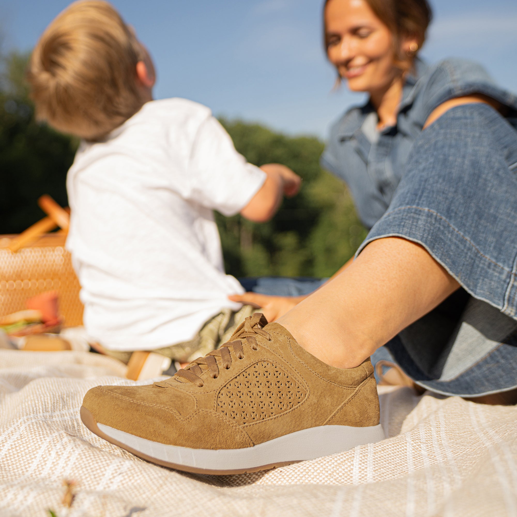 A close-up shot of a brown sneaker shown on foot.