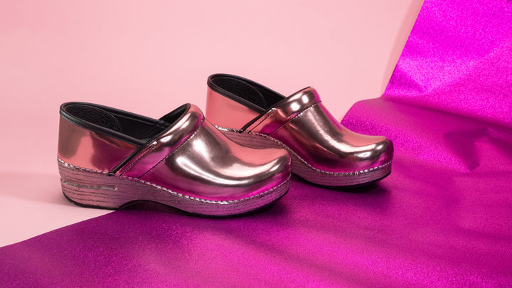 Pink clogs made with trendy metallic letters for standout style.