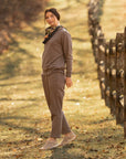 A woman wearing casual outdoor attire and compact, lightweight sneakers.