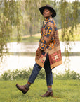 A woman in jeans and a quilt jacket wearing supportive and stylish brown boots.