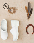 A laydown of true white clogs from Dansko and a variety of barn materials.