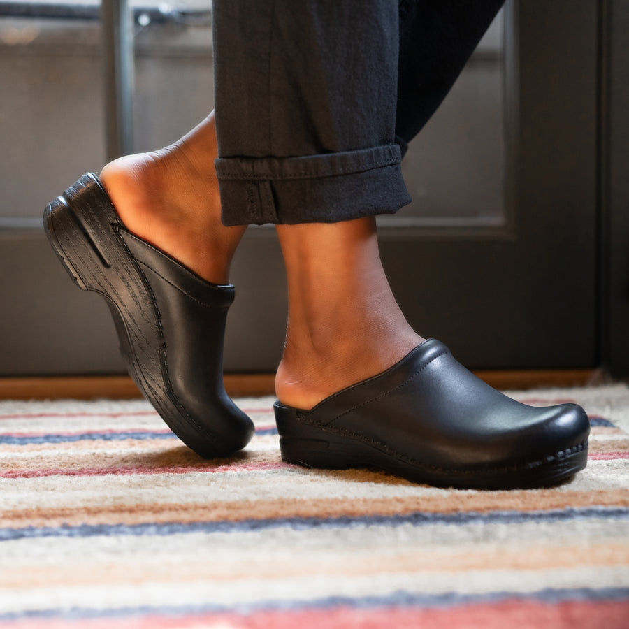 Black mule clog from Dansko styled with black jeans.
