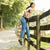 Woman working on a farm wearing brown backless clogs with jeans.