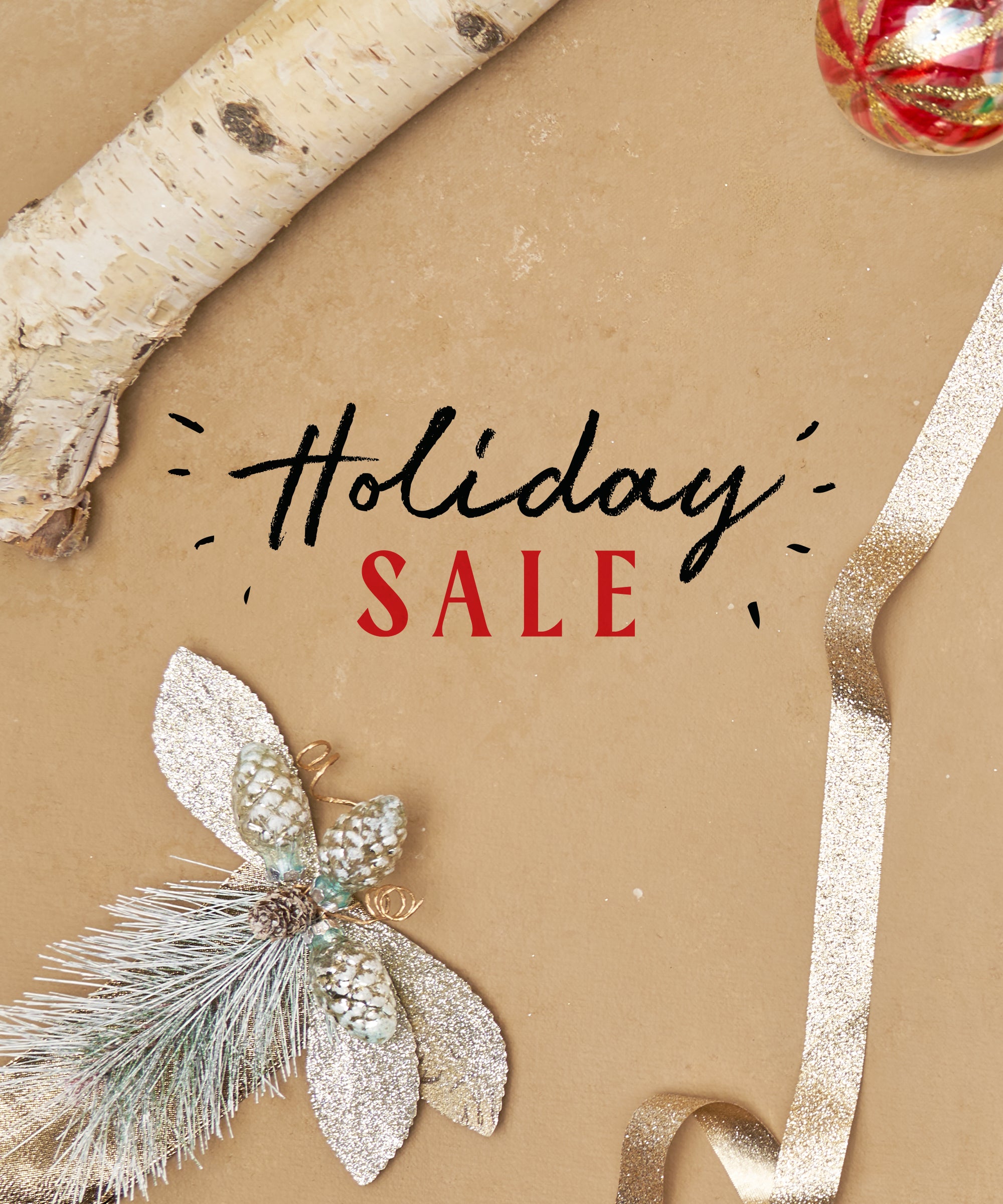 Beige background with silver holiday decor in the foreground and the text "Holiday Sale" in the center.