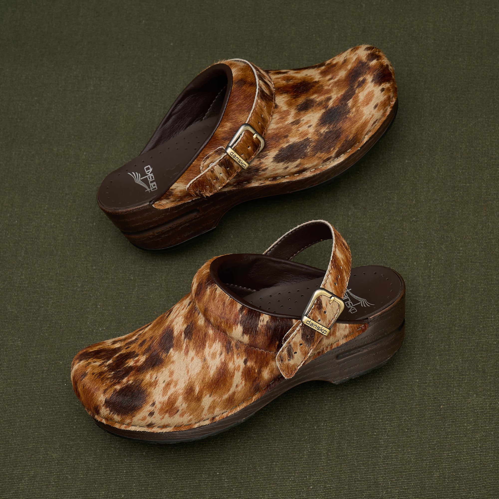 A close-up look at spotted haircalf slingback clogs.