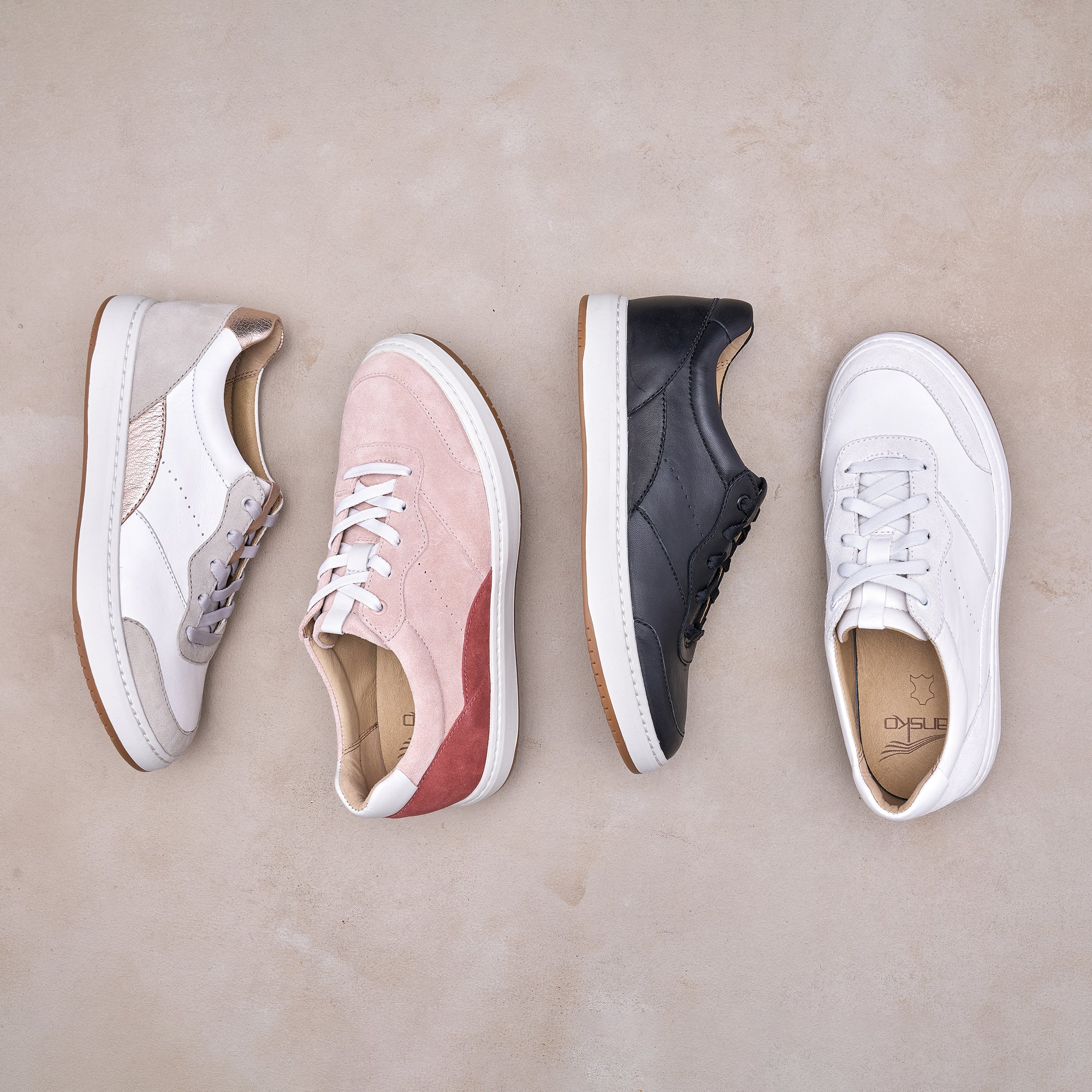 Four colors of a low-profile, casual leather sneaker.