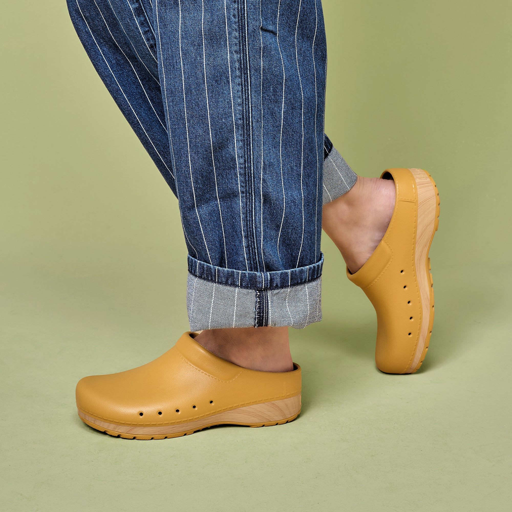 Yellow EVA clogs with a faux wooden sole shown on foot.