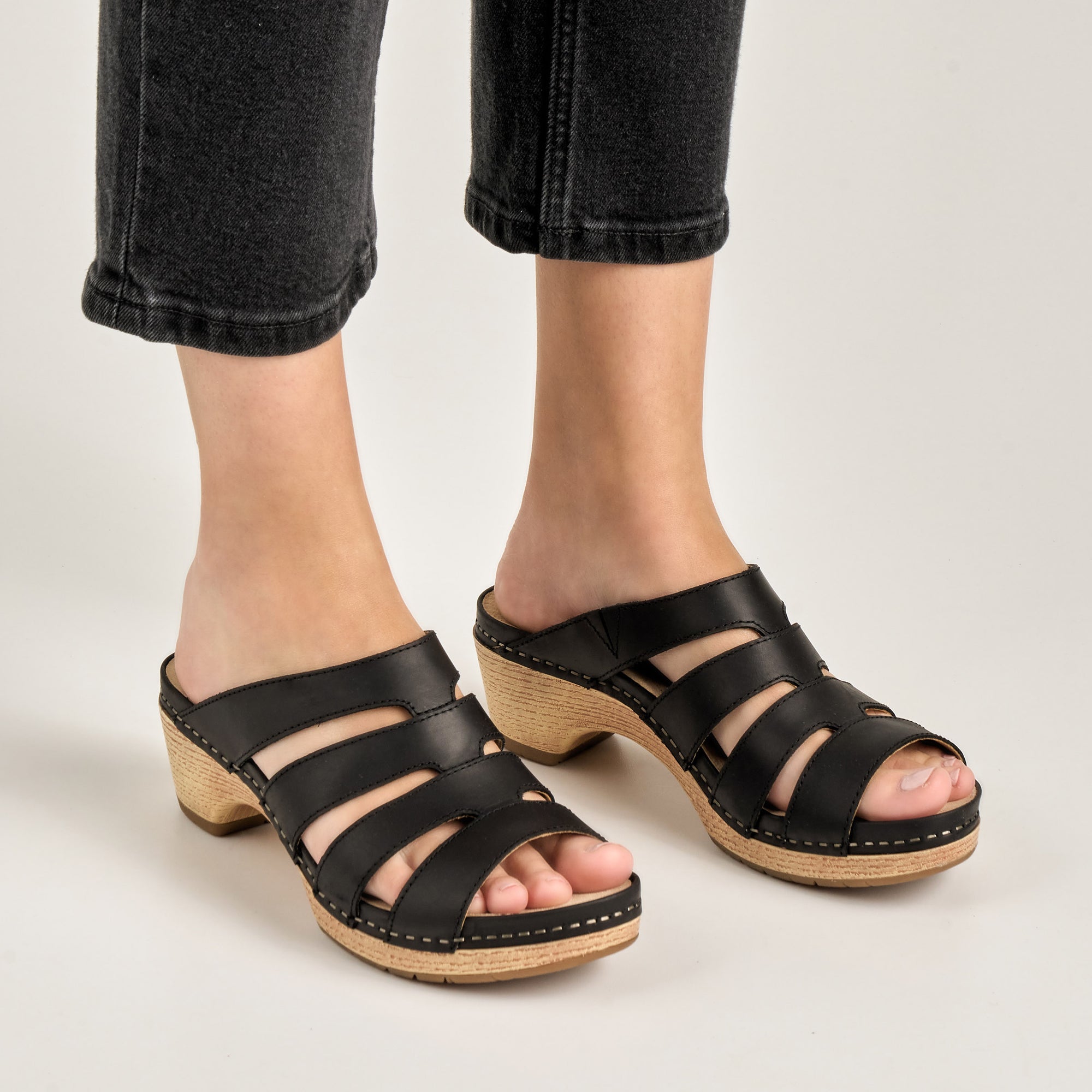 Close up of black strappy sandals.