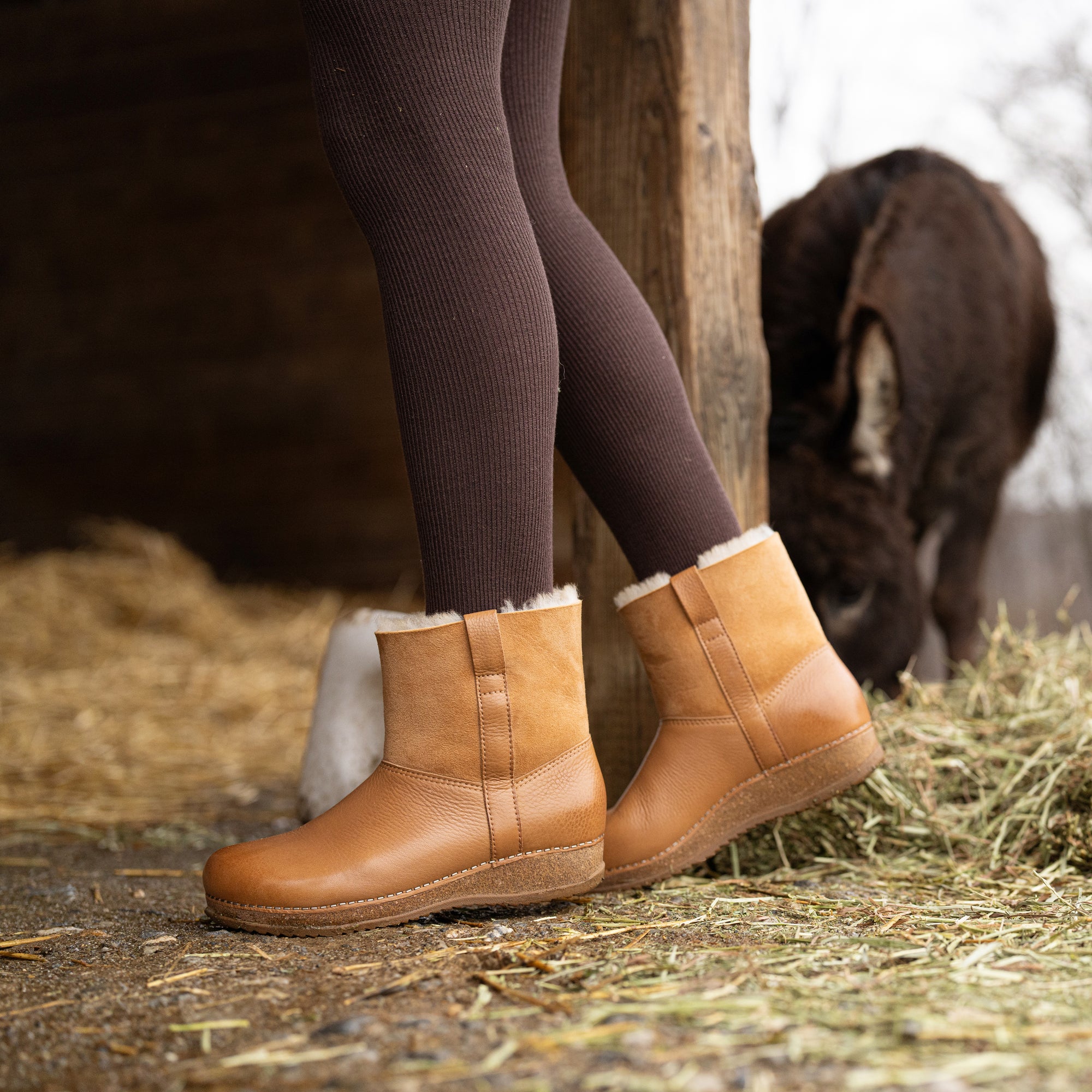 An on-foot look at brown shearling-lined booties.