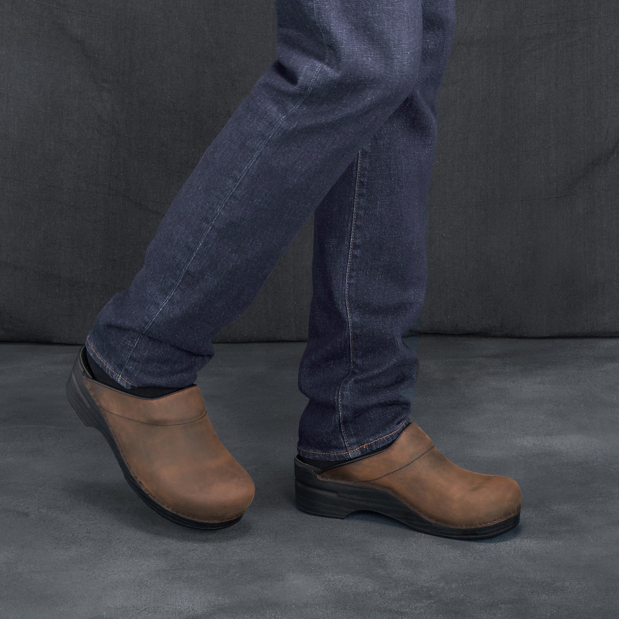 Brown Men&#39;s mule clogs with a supportive outsole.