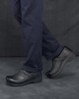 Black men's clogs worn in a casual setting.