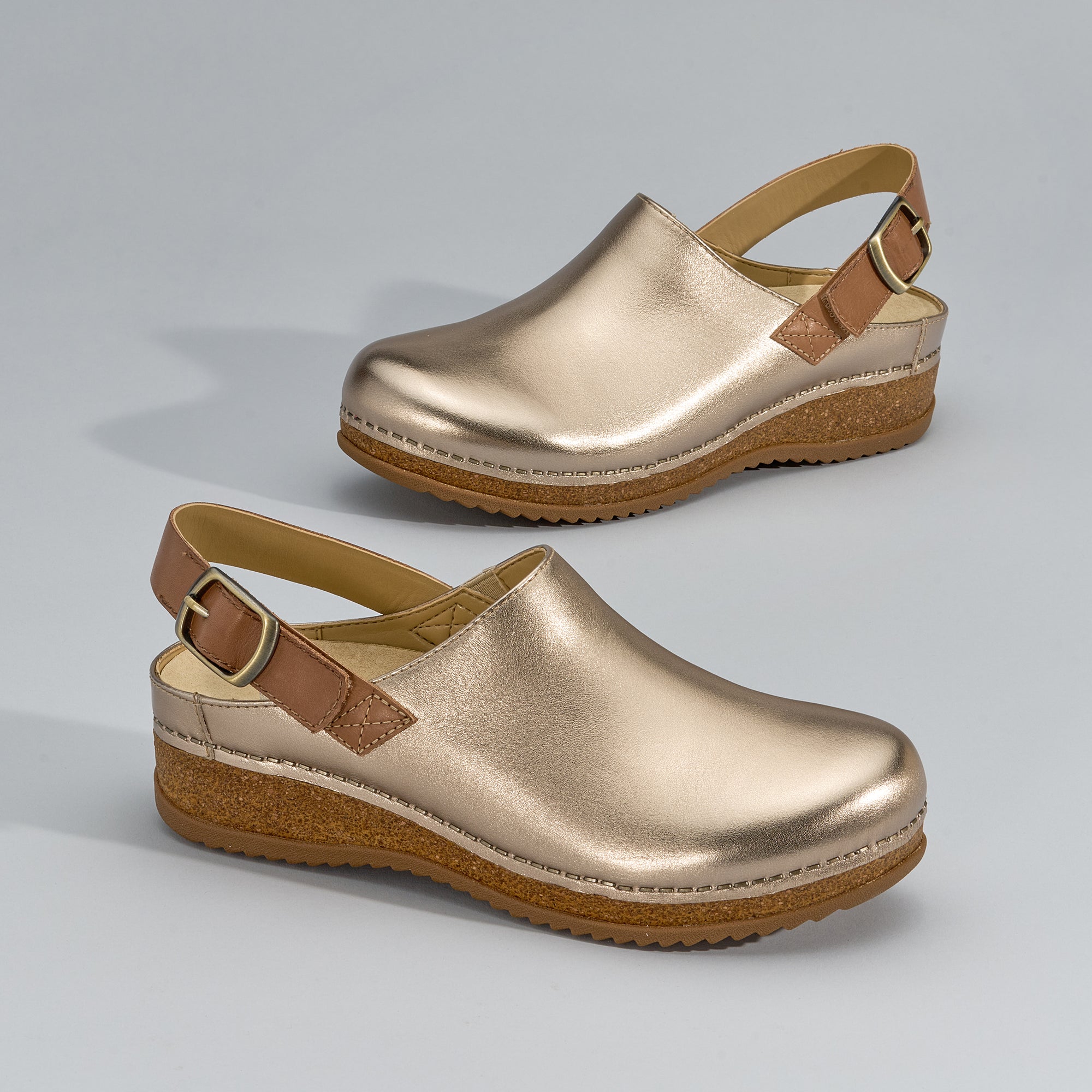 A close-up look at metallic gold slingback clogs.