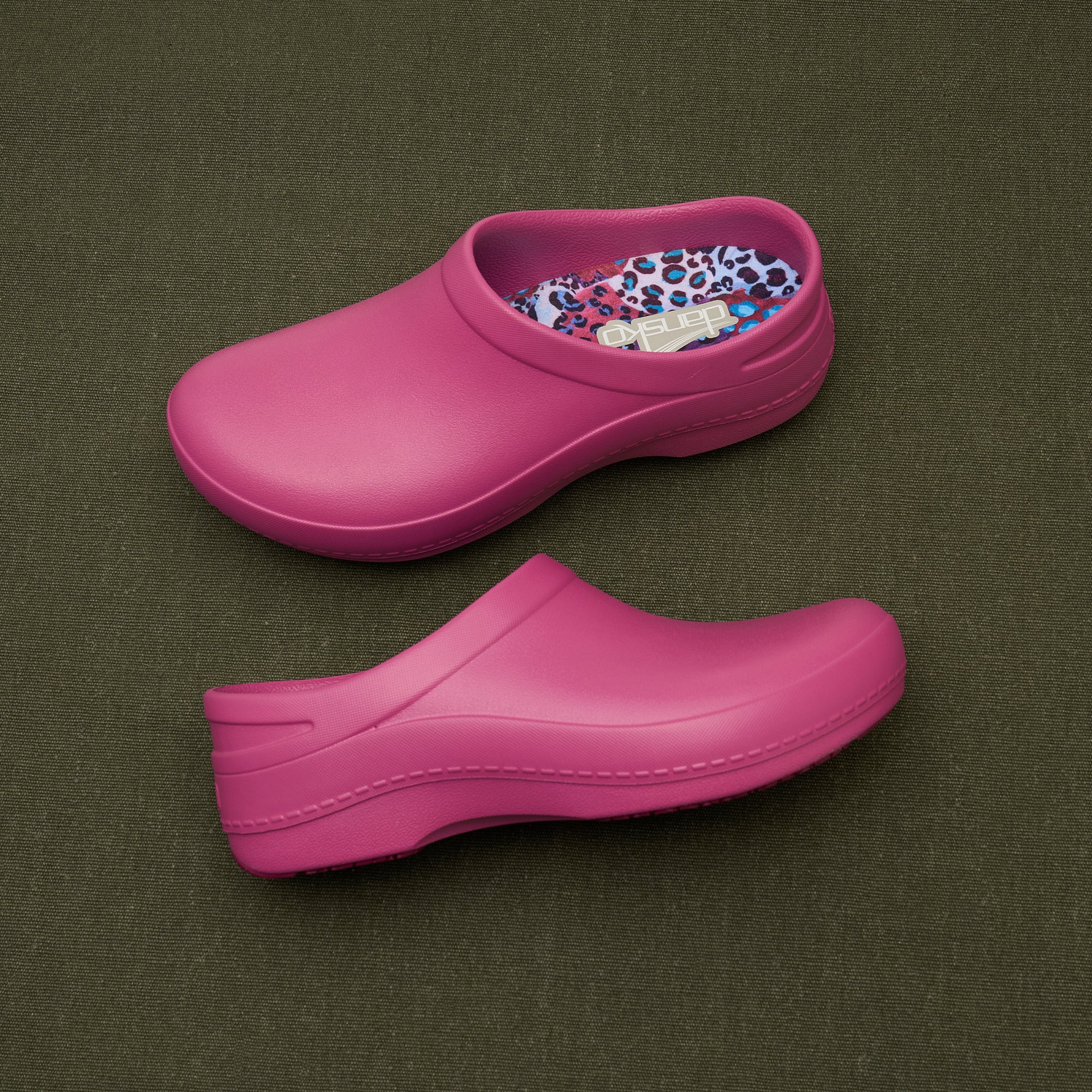 A closeup of pink molded clogs showing the insole design and the upper silhouette.