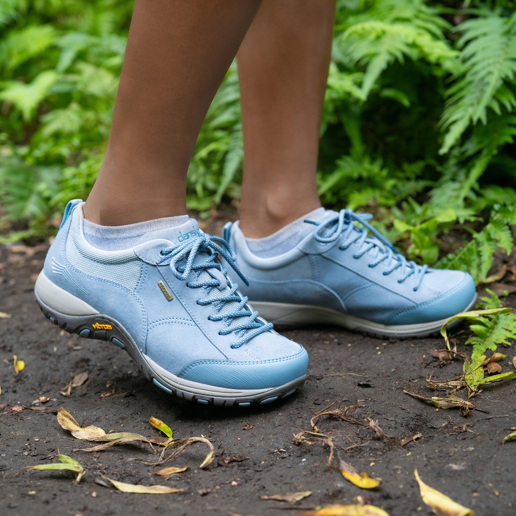 A close up of sky blue outdoor sneakers with a Vibram rubber outsole and durable leather uppers.