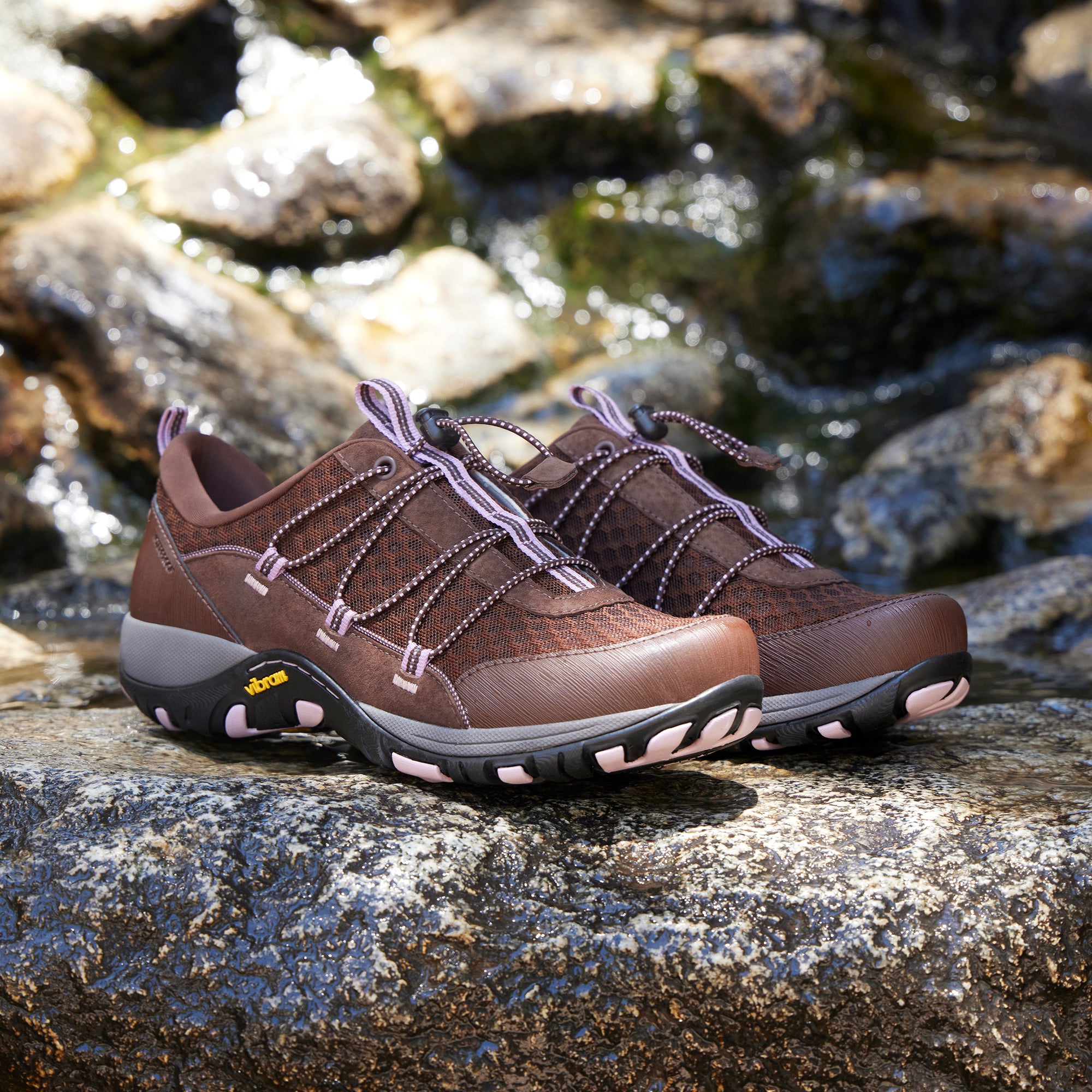 A close-up look of lightweight, brown outdoor sneakers with elastic adjustment.