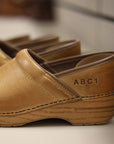 A sample personalization shown on honey distressed clogs.