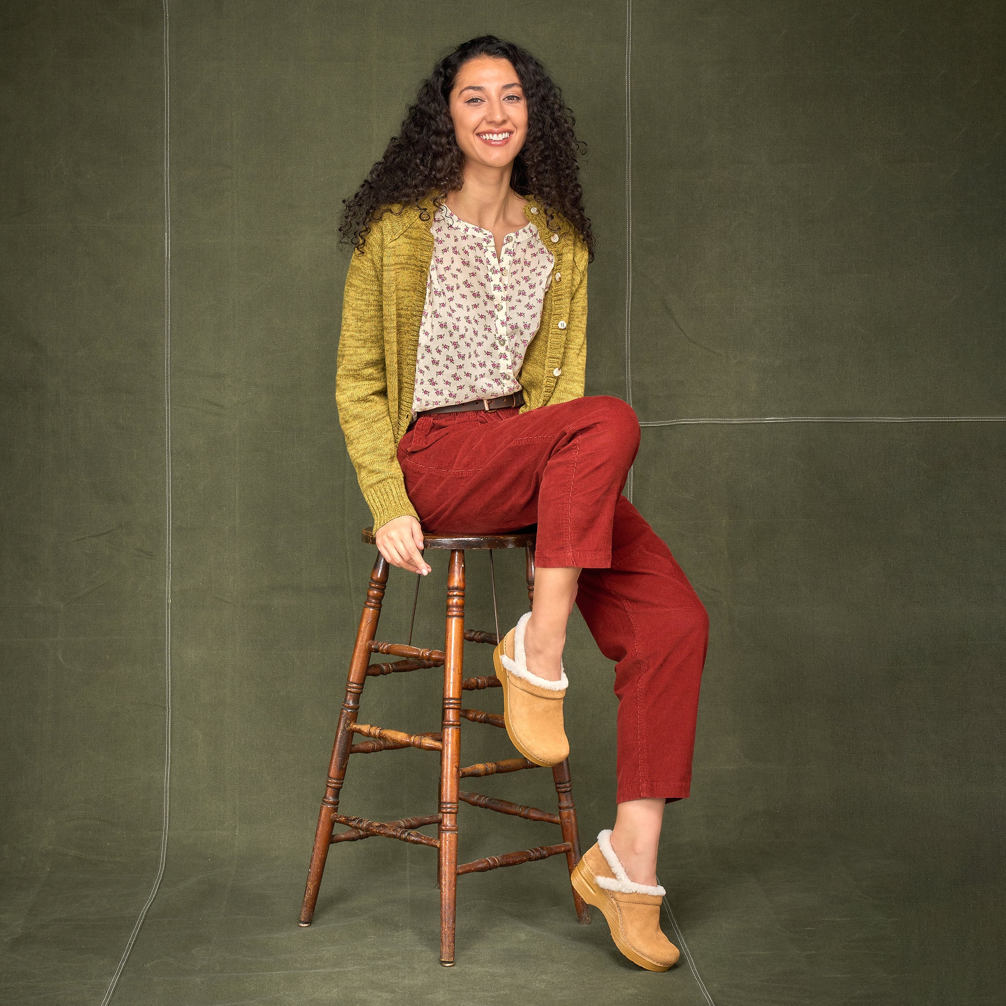 A woman wearing bright colors with cozy Professional clogs.