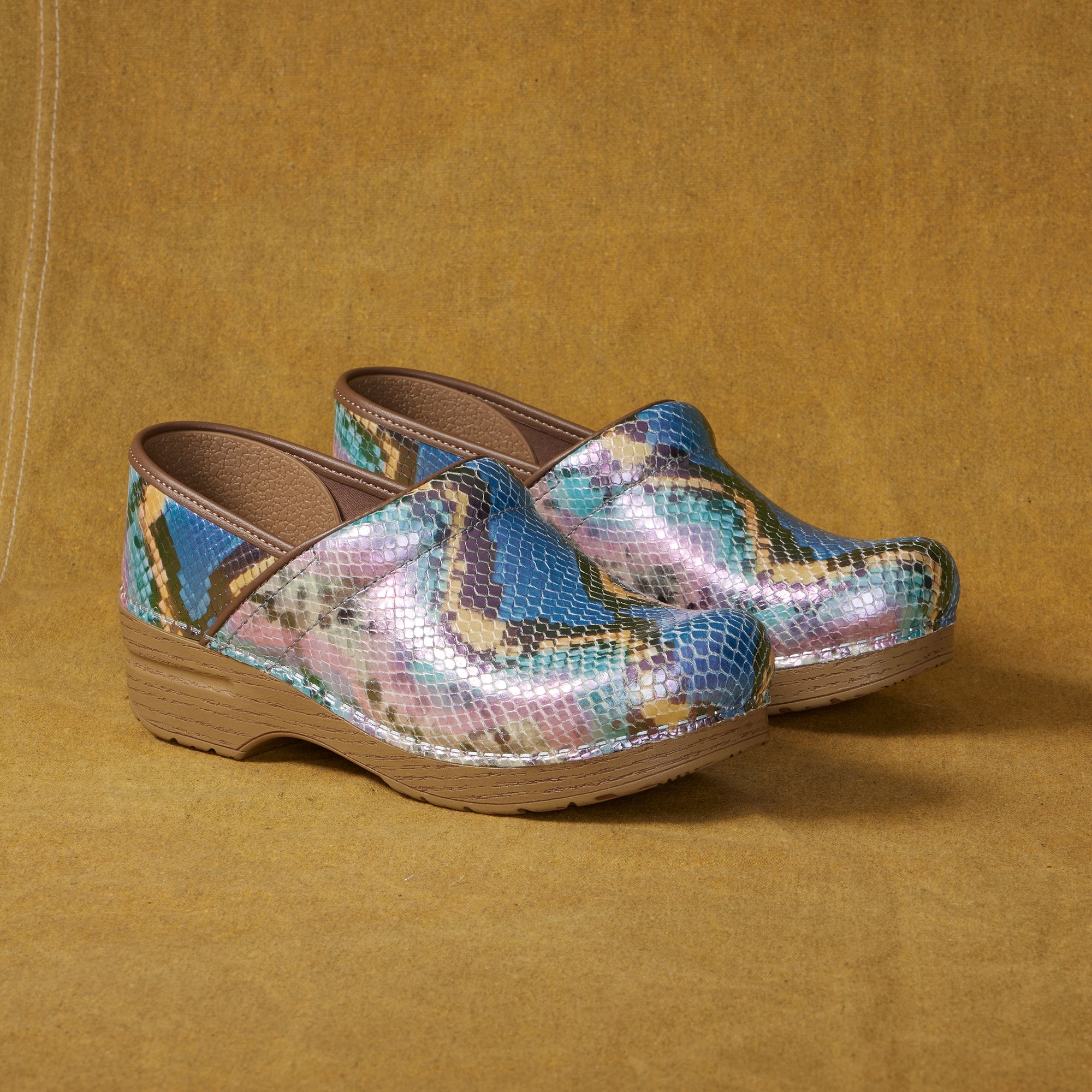 A close up of multicolored mermaid clogs.