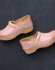 A close-up look at the brightly neutral pink clogs.