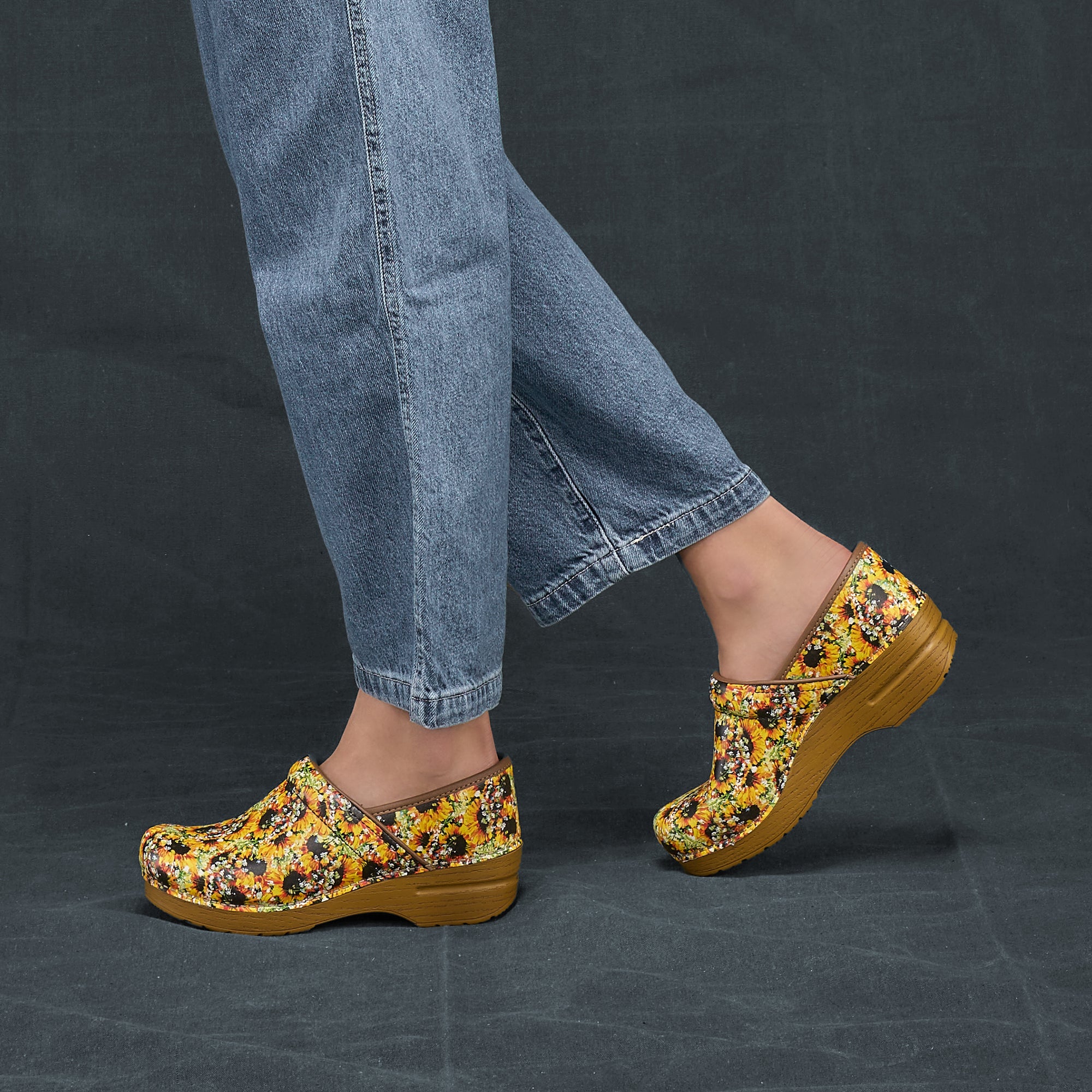 A side view of sunflower leather clogs with a faux leather sole.
