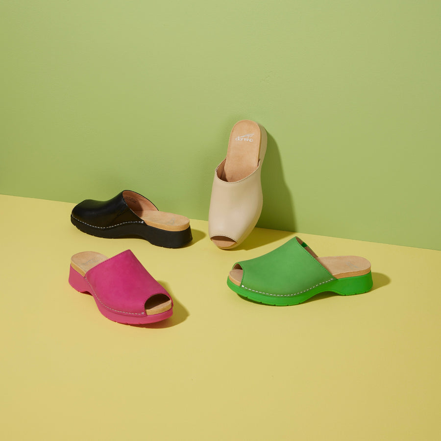 Four slide sandals shown in black, tan, pink, and green.