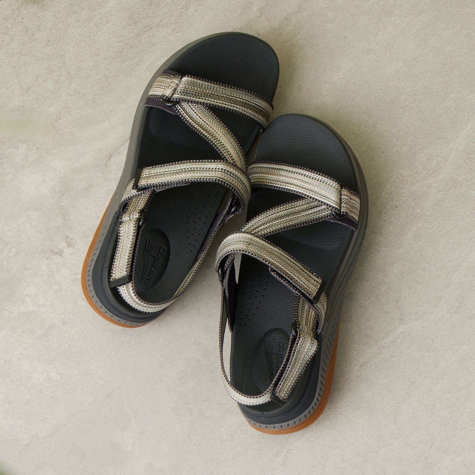 A detailed footbed and strap image of green and black walking sandals.
